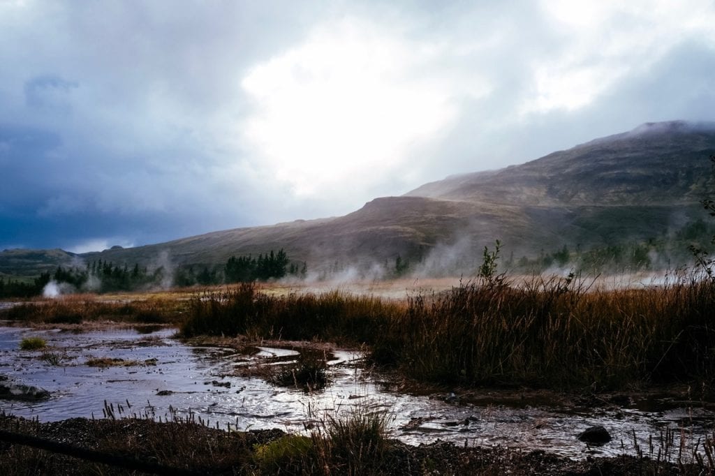 A natural geyser getting ready to erupt near Strokkur hot spring in Iceland. 