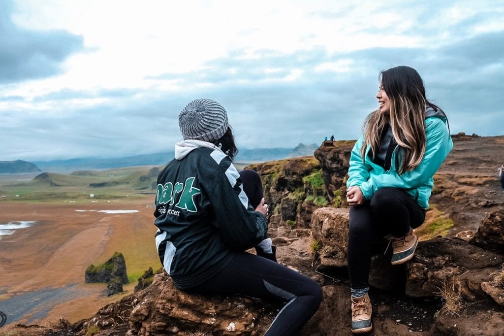 Two girls looking out at Dyrholaey Black Sand Beach