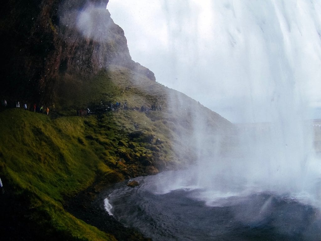 A scenic view of the inside of Seljalandsfoss Waterfall in Iceland.