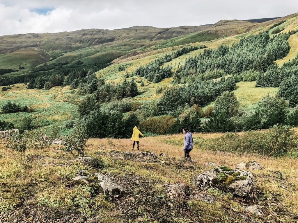 A zoomed out image of two women hiking up Mount Esja in Iceland.