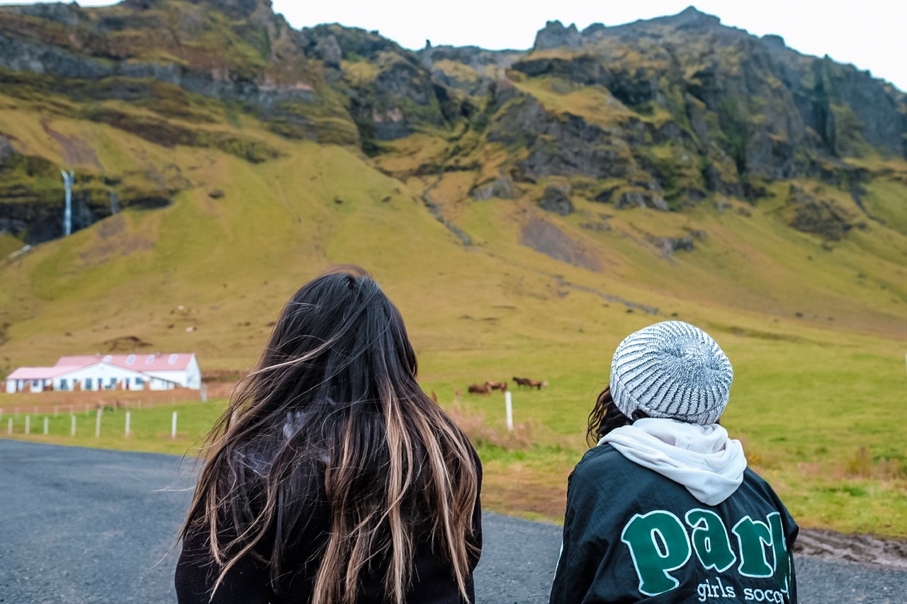 Two women looking out into the hills of Iceland.