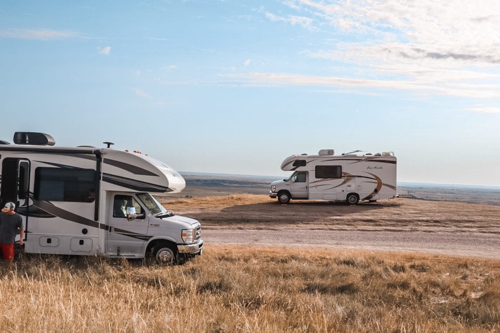Two RV's overlooking the boondocking view in the Badlands on an RV road trip