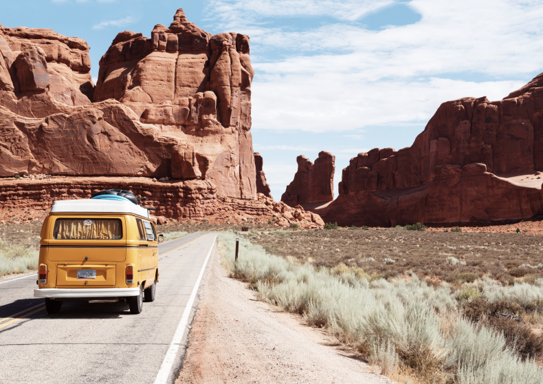 Yellow van driving in the desert