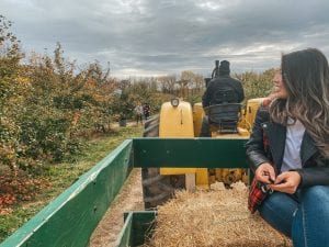 Asian girl on hayride at apple orchard