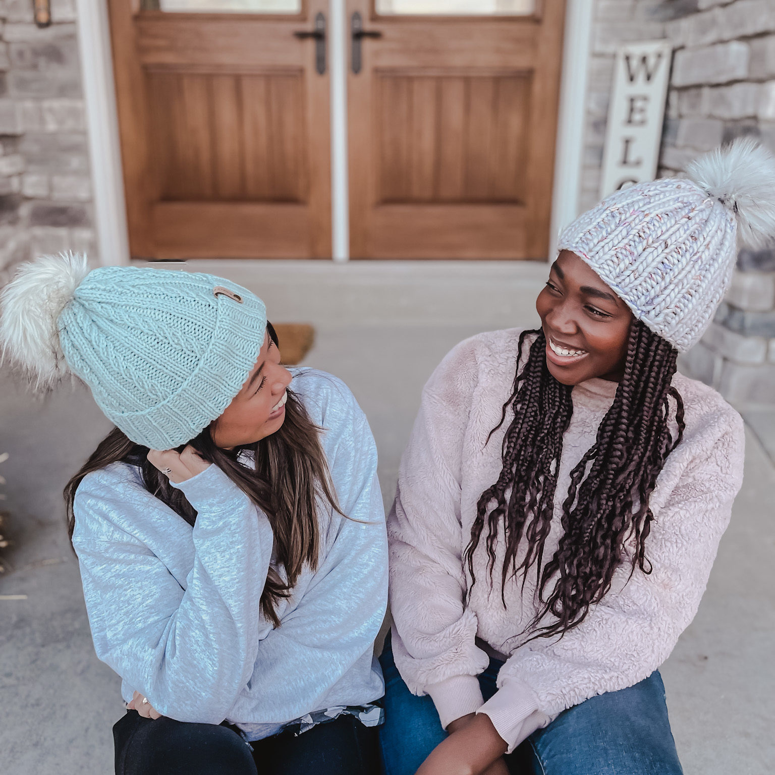 Two girls wearing winter hats 