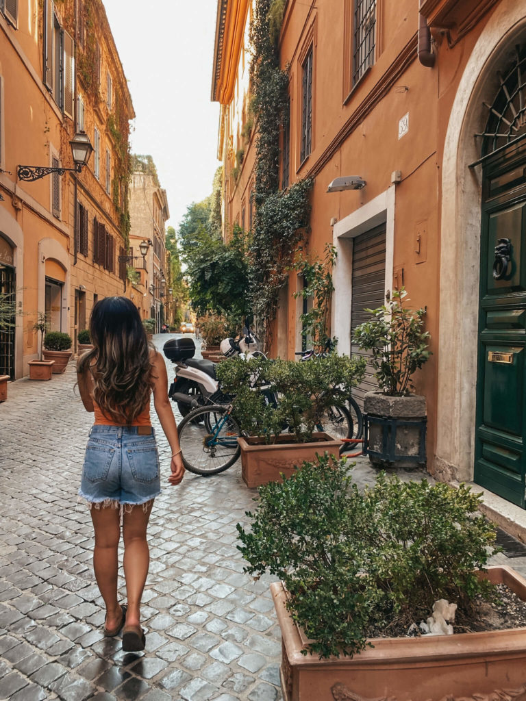 girl walking down street in Rome Italy 
