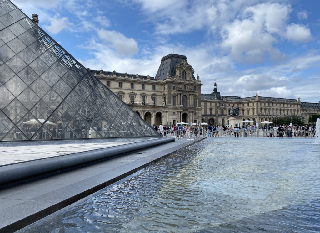 View of the Louvre building and its outside water fountain
