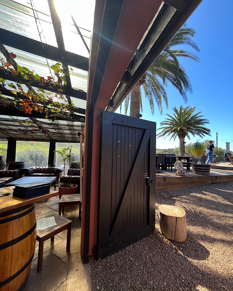 Inside of the winery in Waiheke island with barn doors and palm trees