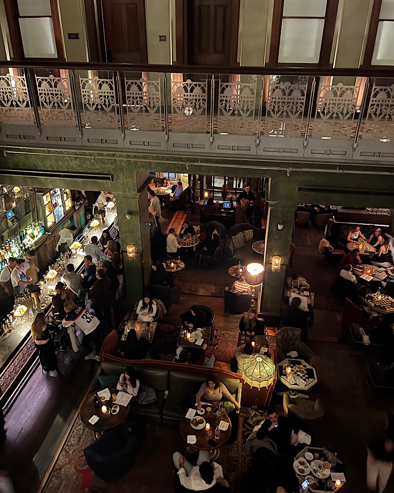 Birdseye view photo looking down at people dining at the Beekman Hotel's restaurant in NYC