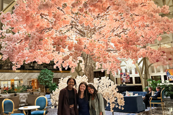 three girls in front of cherry blossoms inside a hotel in Washington DC