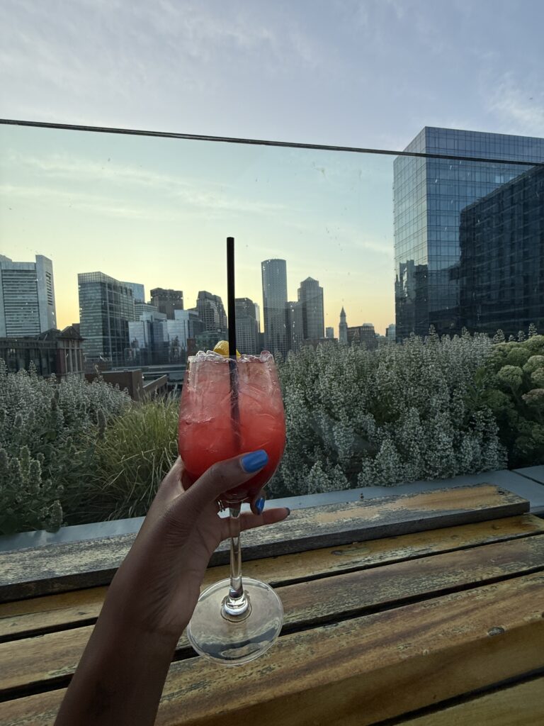 rooftop view with a pink cocktail