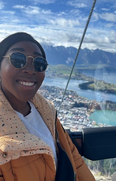 black girl wearing sunglasses on a gondola in New Zealand